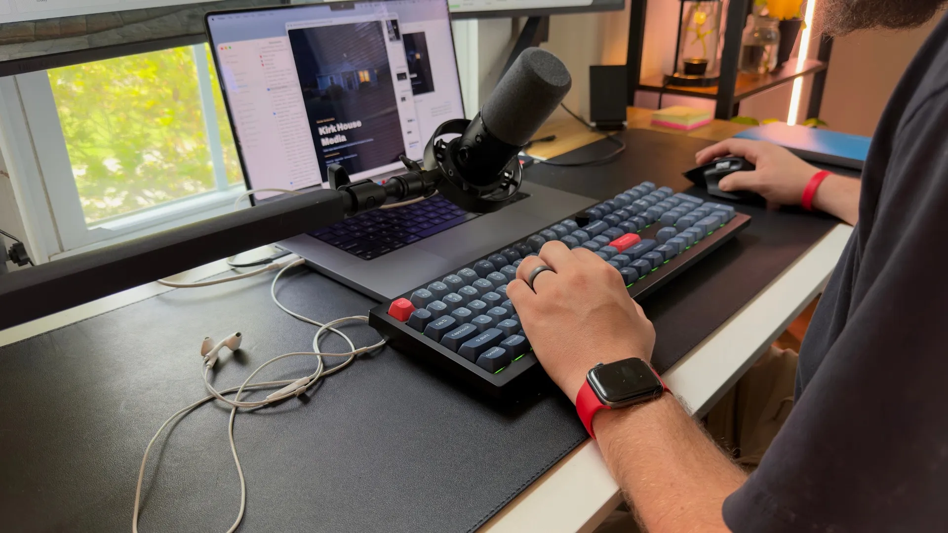 Wyatt Kirk working at his desk, building a website on a laptop and external keyboard